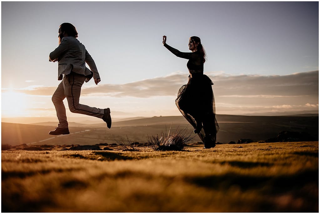 couple in the sunset -skipping on dartmoor