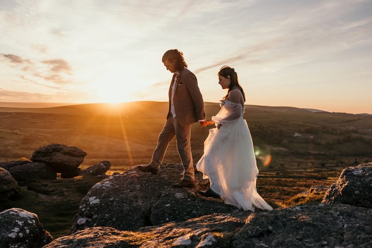 wedding couple walking on dartmoor at sunset